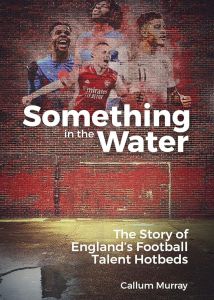 Front cover of “Something in the Water”, by Callum Murray. Four footballers set against the background of a brick wall with a football goal painted on it.